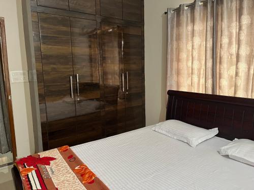 a bedroom with a bed and a glass shower at 2 BHK Apartment at Gachibowli in Hyderabad