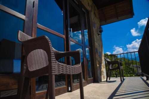 two chairs on the porch of a house at Ever Breeze Ella Hotel in Ella
