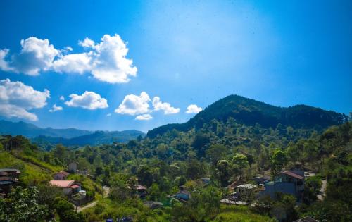 a view of a mountain with houses and trees at Ever Breeze Ella Hotel in Ella
