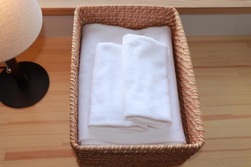 a basket with towels sitting on top of a floor at Cider Barn &more in Iida