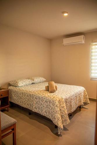 a bedroom with a bed with a teddy bear on it at Downtown Beach Condo w/ Pool in Cabo San Lucas