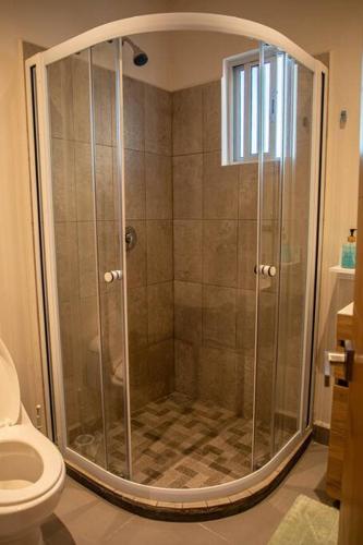 a shower with a glass door in a bathroom at Downtown Beach Condo w/ Pool in Cabo San Lucas