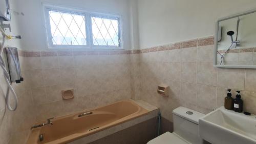 a bathroom with a tub and a toilet and a sink at Luxpro Luxury Villa / Seremban 2 / Private Swimming Pool in Seremban