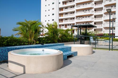 a hot tub in front of a building at OASIS TROPICAL HOTEL in Santa Marta