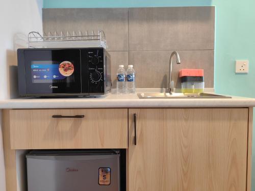 a microwave oven sitting on top of a kitchen counter at Near Airport K Avenue Family Room in Donggongon