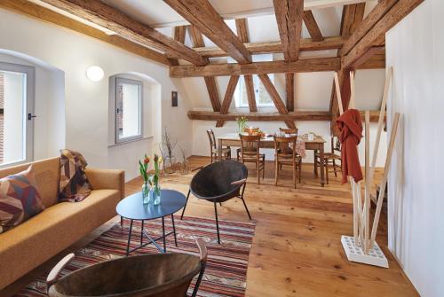 a living room with a couch and a table at Engelwirt Hotel & Apartments in Berching
