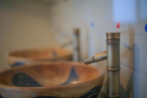 a close up of a wooden bathroom sink with a faucet at Ningbo 238 International Youth Hostel in Ningbo