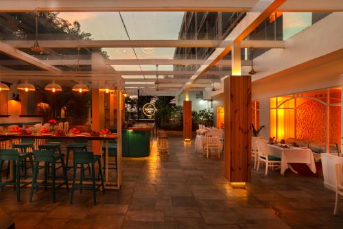 a restaurant with tables and chairs and a bar at Radisson Blu Bengaluru Outer Ring Road in Bengaluru
