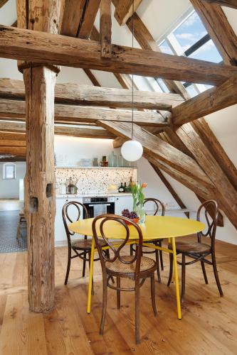a dining room with a yellow table and chairs at Engelwirt Hotel & Apartments in Berching