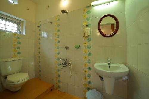 a bathroom with a toilet and a sink at Bella Boutique Homestay in Alleppey