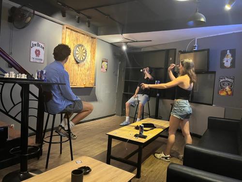 a group of people in a barber shop at Saigon Hub Hostel in Ho Chi Minh City
