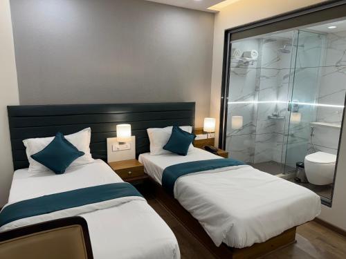Ένα ή περισσότερα κρεβάτια σε δωμάτιο στο HOTEL CITADELL DE DAMAN