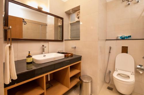 La salle de bains est pourvue d'un lavabo et de toilettes. dans l'établissement Mayfair World Cup Village, à Rourkela