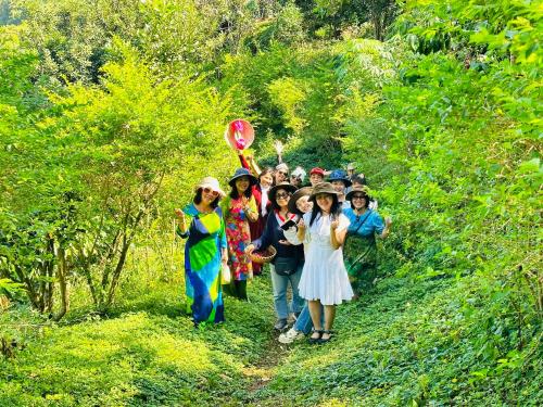 a group of people walking down a trail at Tám Trình Coffee Farm in Hoat