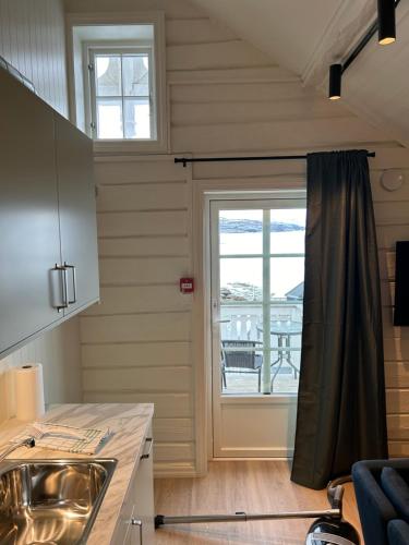 a kitchen with a sink and a window at Finsnes Gaard in Finnsnes
