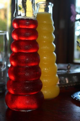a stack of red and yellow vases on a table at Umoya in Hilton