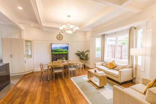 a living room with a couch and a table at Feels like your home ! in Auckland
