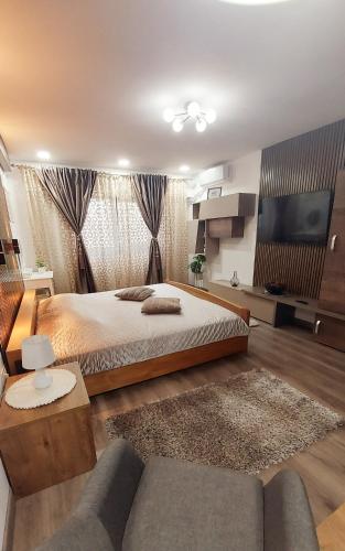 a large bedroom with a bed and a couch at Cuza 21 in Brăila
