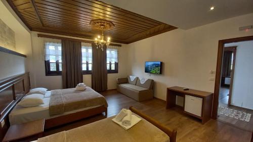 a large room with two beds and a couch at Castle Hotel in Gjirokastër