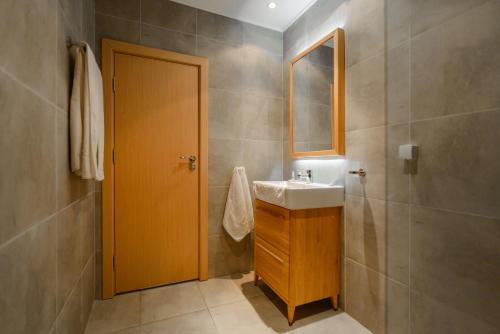 a bathroom with a sink and a mirror at Hotel Sunrise Golden Sands in Golden Sands