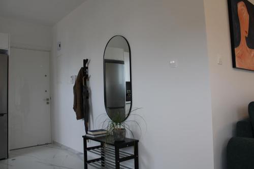 a mirror sitting on a stand next to a room at Hypnos Residence in Nicosia