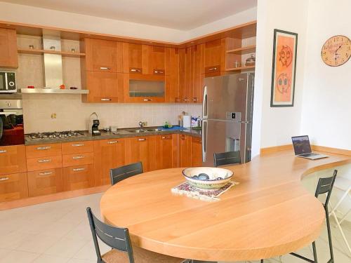 a kitchen with a wooden table with a bowl on it at Appartamento al Lago in Castiglione del Lago