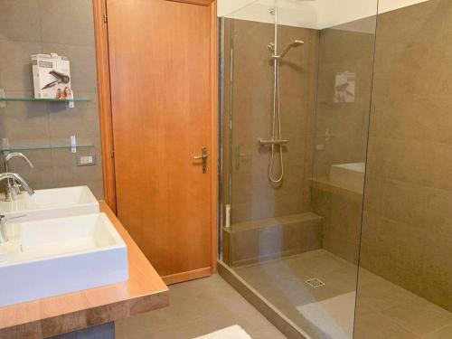 a bathroom with a shower and a sink and a shower at Appartamento al Lago in Castiglione del Lago