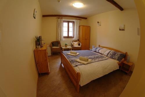 a bedroom with a bed with two towels on it at Penzion Hradební in Telč