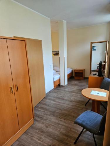 a small room with a table and a bed at Parkhotel del Mar in Sassnitz