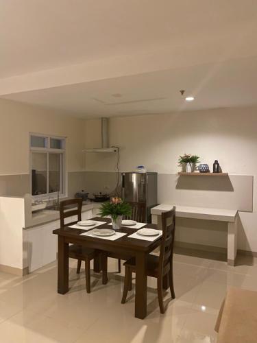 a kitchen with a table and chairs in a room at Amar Residence in Iligan