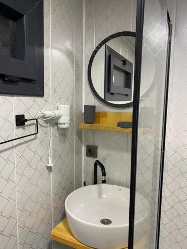 a bathroom with a white sink and a mirror at Ritiny House in Ardeşen