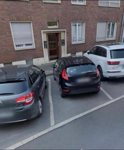 a group of cars parked in a parking lot at Stilvolle Luxus City-Apartment in Viersen