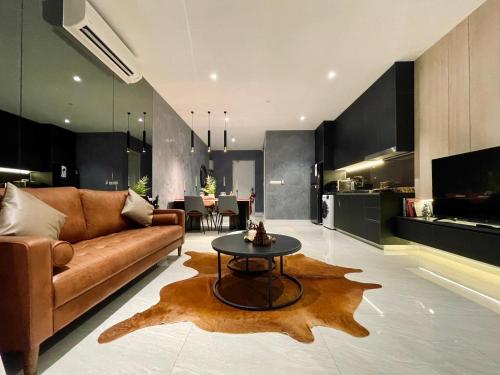 a living room with a couch and a table at QUILL RESIDENCE 1018 in Kuala Lumpur