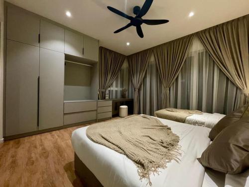 a bedroom with two beds and a ceiling fan at QUILL RESIDENCE 1018 in Kuala Lumpur