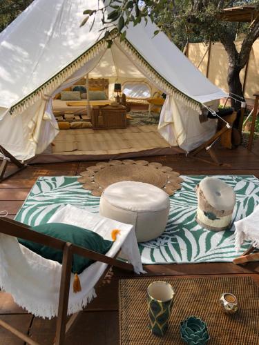 a canvas tent with a bed and a table at Glamping - La Casa del Piano in Chiclana de la Frontera
