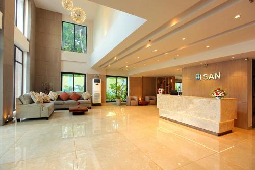 a large lobby with a sam sign on the wall at HOTEL SAN in Kollam