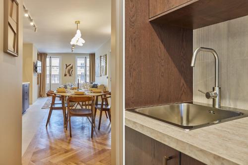 - une cuisine et une salle à manger avec un évier et une table dans l'établissement Apartment Le Marais by Studio prestige, à Paris