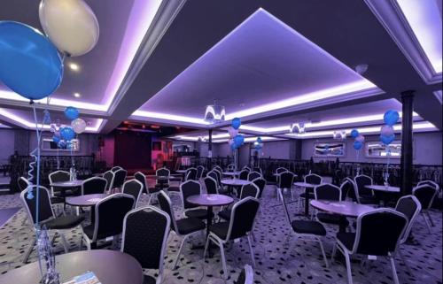 a banquet hall with tables and chairs and balloons at Cozy Private Static Caravan at Llyons Robin Hood - Silver Birch Way 11 in Rhyl