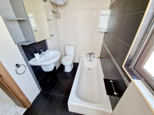 a small bathroom with a toilet and a sink at Penthouse with Large Terrace close to Seafront in St. Paul's Bay