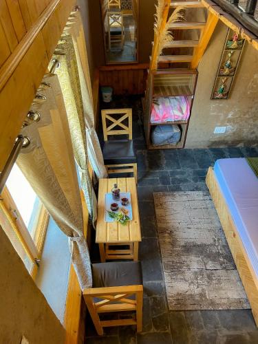an overhead view of a room with a table and beds at Sainj Riverside Cottages in Sainj