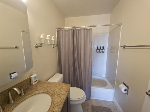 a bathroom with a sink and a toilet and a shower at Castro Place in Downtown San Leandro in San Leandro