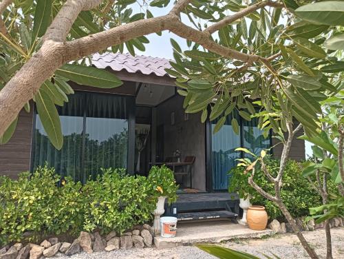 a house with a bench in front of it at สุขเสมอ โฮมสเตย์ (Suk-Samer homestay) in Ban Nong Phao Than