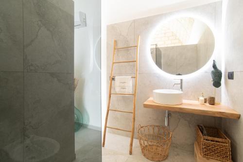 a bathroom with a sink and a mirror at Vicoloterzo Suite in Bari