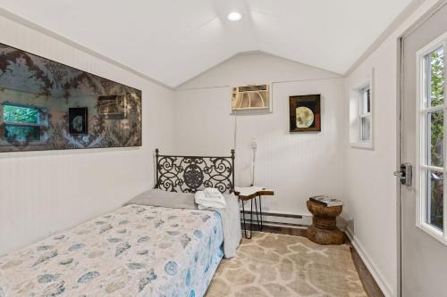 a bedroom with a bed and a window at The Garden Downtown Steps to Waterfront in Newburyport