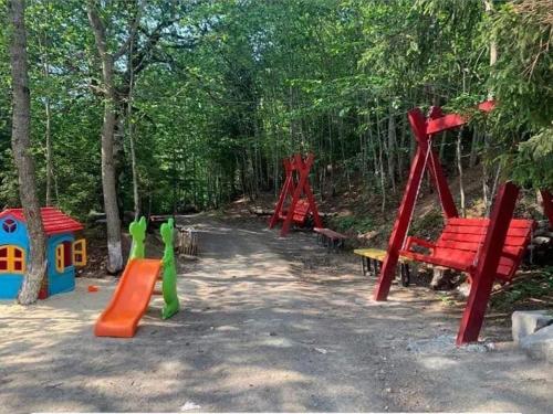 a group of playground equipment in the woods at bakuriani didveli rezidensi G6 in Borjomi