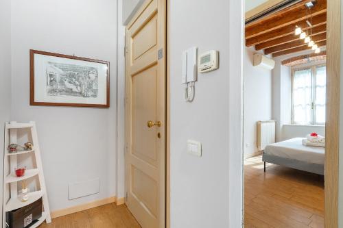 a hallway with a door and a bed in a room at “Antica terrazza” Charme&relax in Bergamo