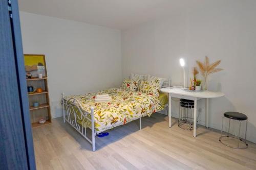 a bed in a room with a table and a bed and a bed at Cozy studio@Champs Élysée in Paris