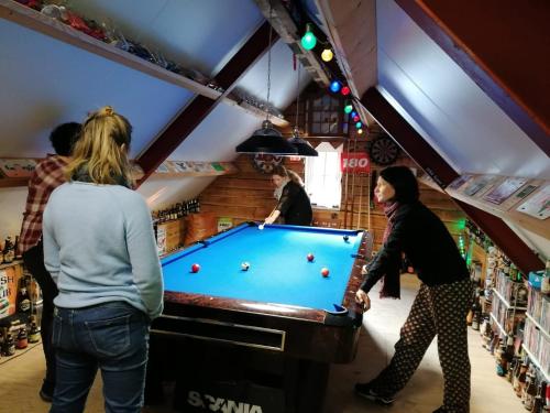 a group of people playing pool in a store at Koekwhouse Bed and Breakfast, Bierbrouwerij in Nispen