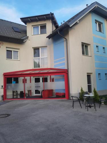 a red building with tables and chairs in front of it at Holding in Tulln