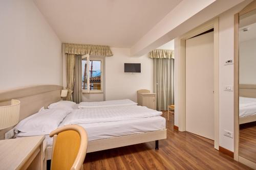 Hotel San Marco tesisinde bir odada yatak veya yataklar
